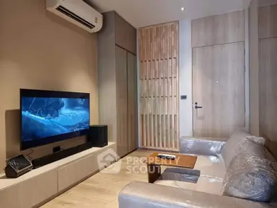 Modern living room with sleek furniture and wall-mounted TV