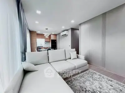 Modern living room with sleek design and open kitchen layout