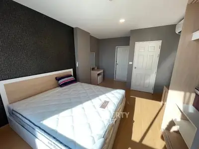 Spacious bedroom with modern decor and ample natural light