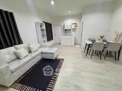 Spacious modern living room with elegant dining area and cozy seating.