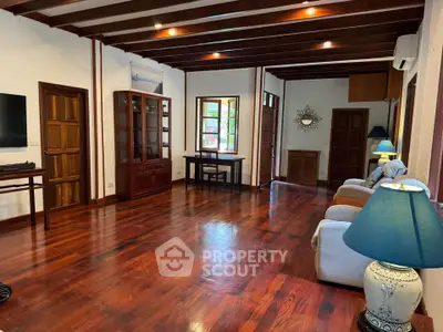 Spacious living room with wooden flooring and elegant decor