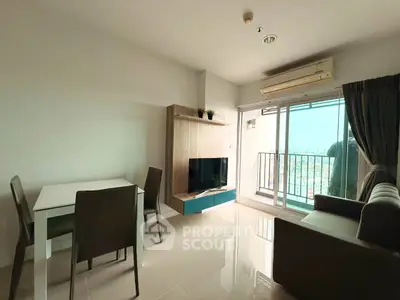 Modern living room with balcony and city view, featuring sleek furniture and natural light.