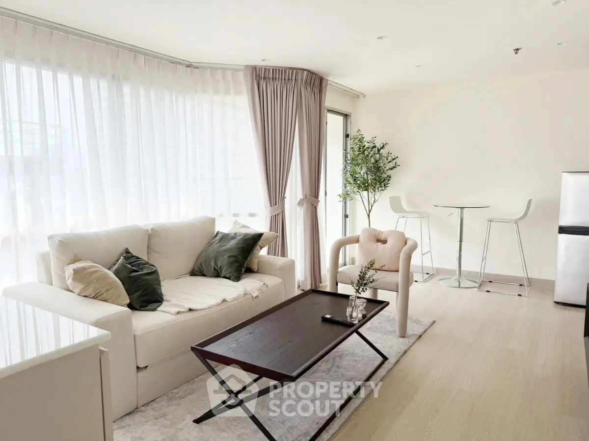 Bright and modern living room with elegant furniture and large windows