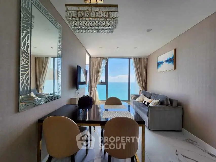 Luxurious living room with ocean view, elegant decor, and modern furnishings.