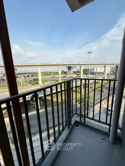 Modern balcony with urban view and highway access, perfect for city living.