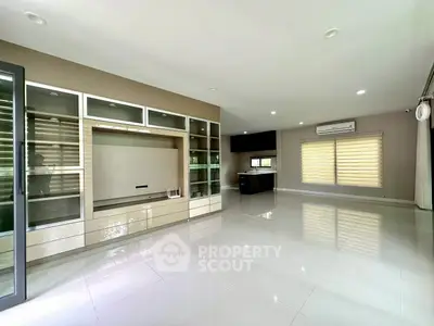 Spacious modern living room with sleek built-in storage and large windows