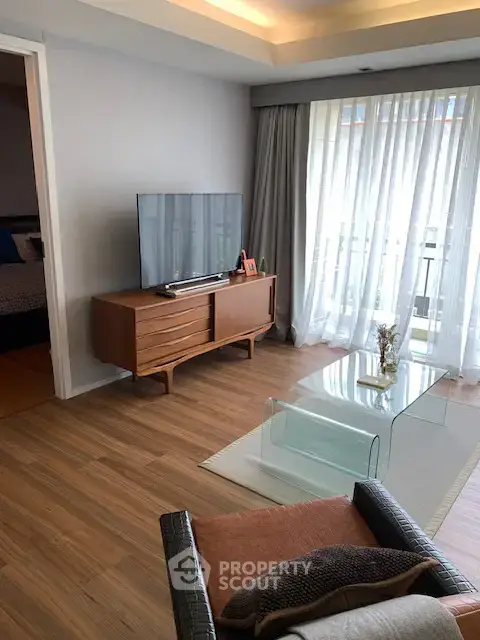 Modern living room with stylish furniture and large window for natural light.