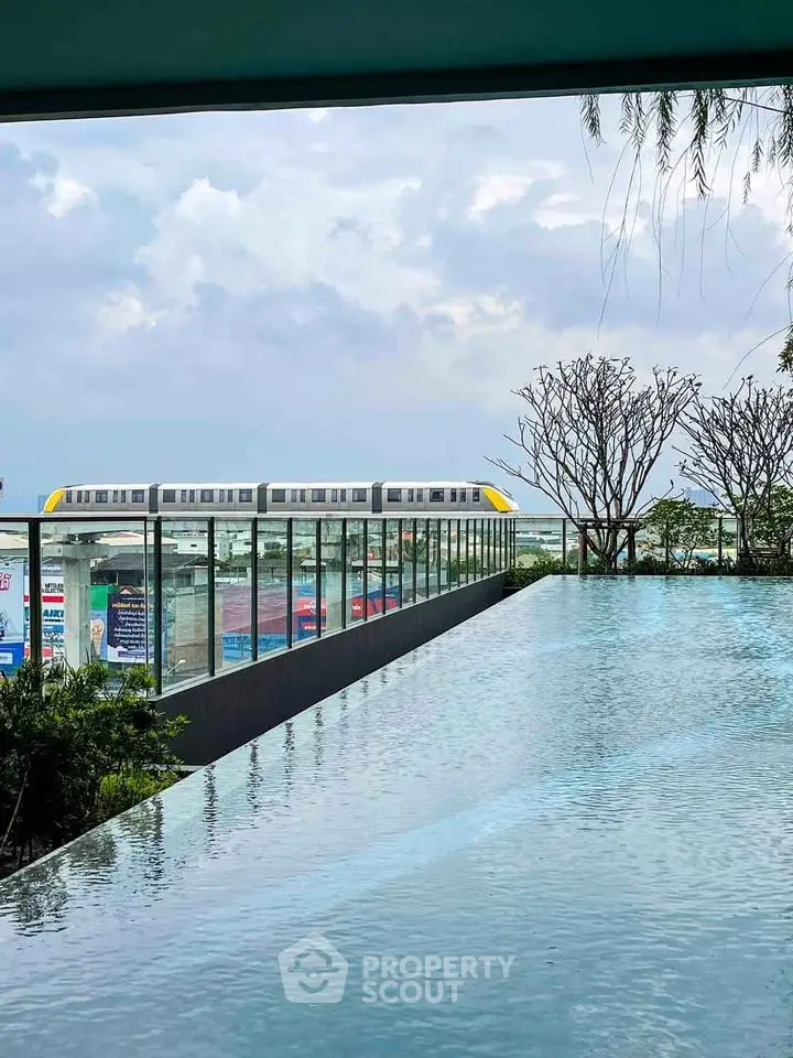 Stunning rooftop infinity pool with city skyline and train view