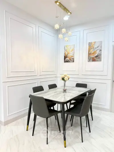 Elegant dining area with modern decor and stylish lighting, perfect for intimate gatherings.