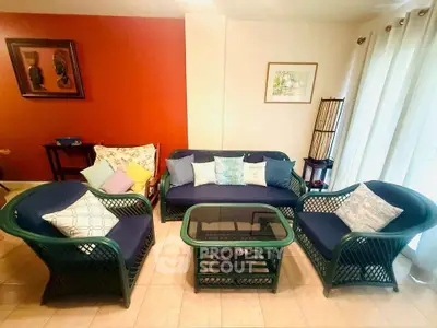 Charming living room with stylish wicker furniture and colorful cushions, perfect for cozy gatherings.