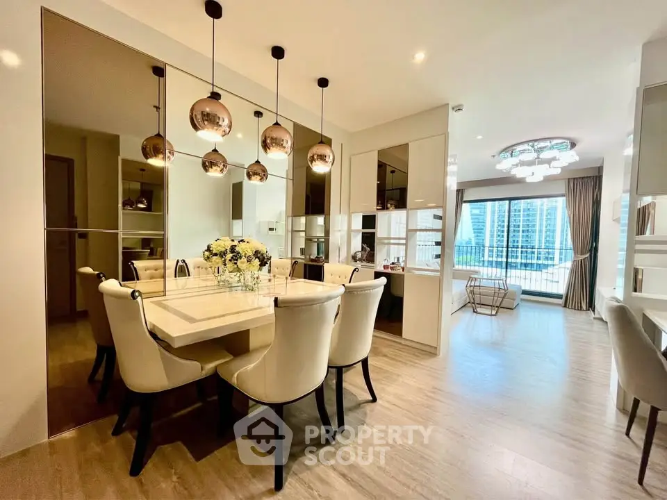 Luxurious dining area with elegant lighting and spacious living room view