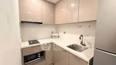 Modern kitchen with sleek cabinetry and built-in appliances in a compact layout.