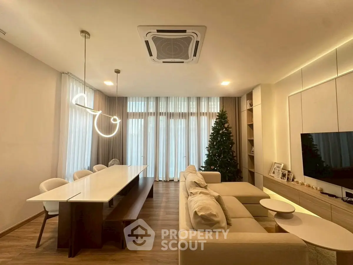 Modern living room with elegant dining area and stylish lighting