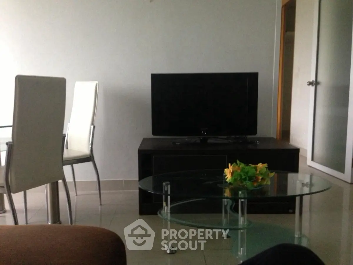 Modern living room with sleek furniture and flat-screen TV, perfect for relaxation and entertainment.
