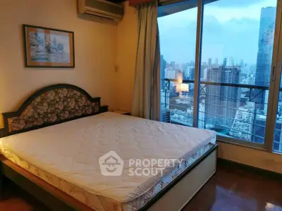 Spacious bedroom with city view in high-rise apartment