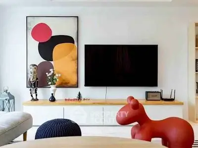 Modern living room with stylish decor and wall-mounted TV