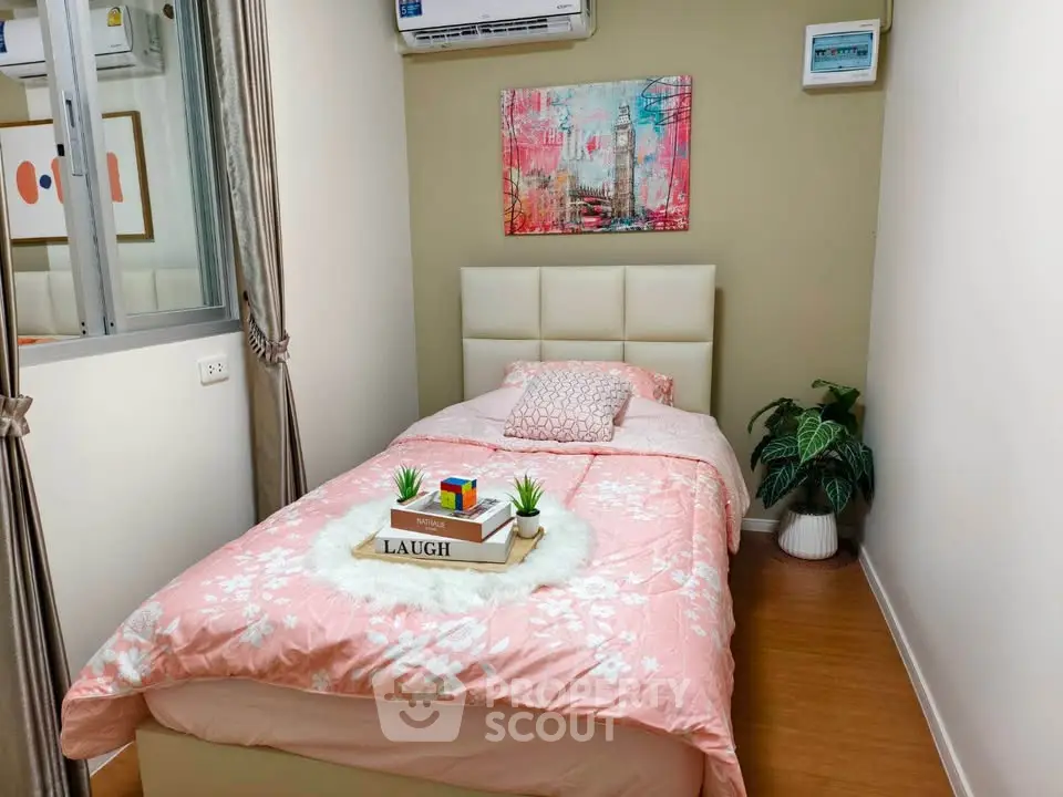 Cozy bedroom with stylish decor and air conditioning, perfect for relaxation.