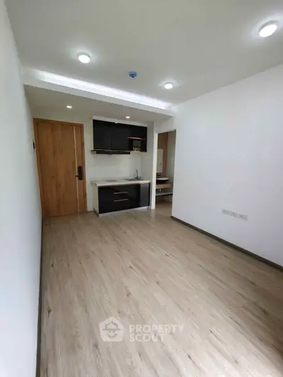 Modern minimalist apartment interior with open kitchen and wooden flooring