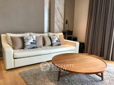 Stylish living room with modern sofa and round wooden coffee table on a cozy rug.