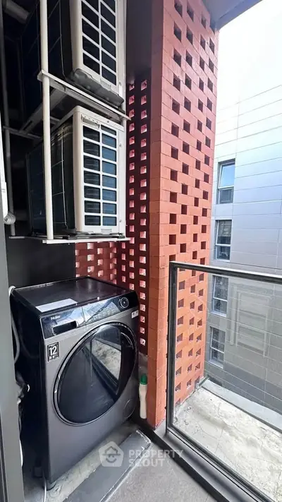 Modern apartment balcony with washing machine and brick wall design