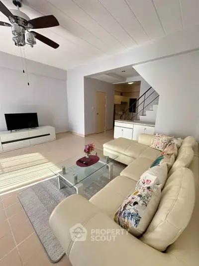 Spacious living room with modern decor and cozy seating area