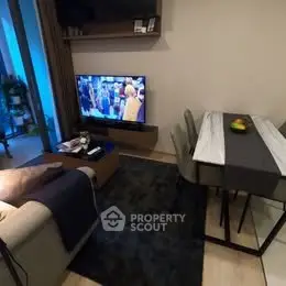 Cozy living room with modern decor and dining area, perfect for relaxation and entertainment.