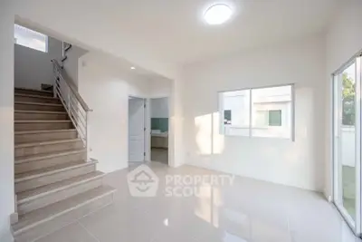 Bright and spacious interior with modern staircase and large windows