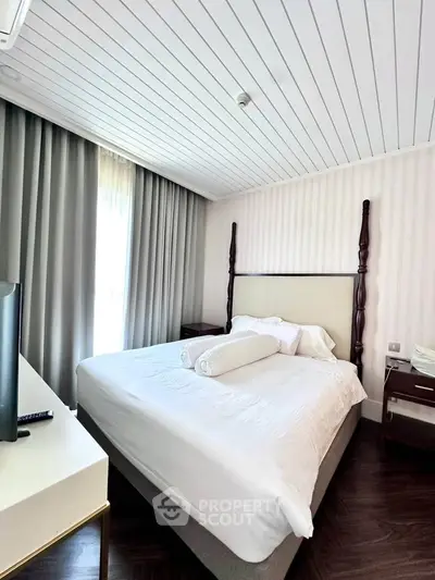 Elegant bedroom with stylish decor and natural light, featuring a cozy bed and modern furnishings.