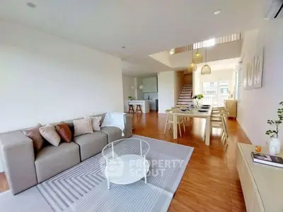 Spacious open-plan living and dining area with modern decor and natural light.