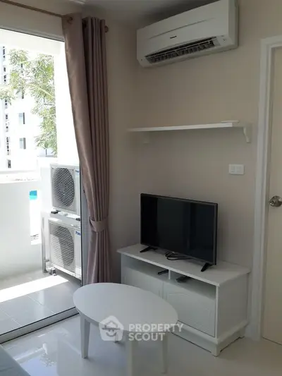 Modern living room with air conditioning and balcony access in a stylish apartment.