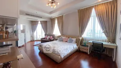 Luxurious bedroom with elegant decor and ample natural light