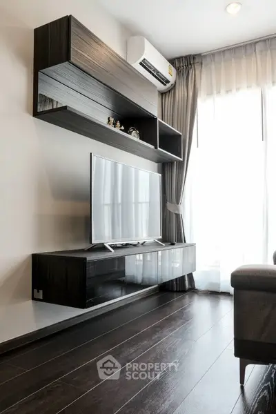Modern living room with sleek TV unit and natural light