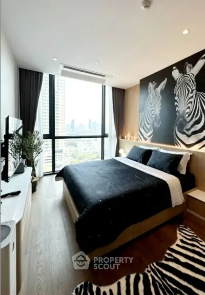 Luxurious bedroom with stunning city view and zebra-themed decor
