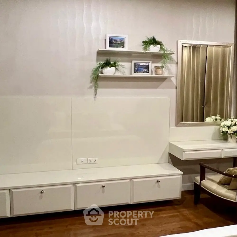 Elegant bedroom with modern white furniture and decorative plants