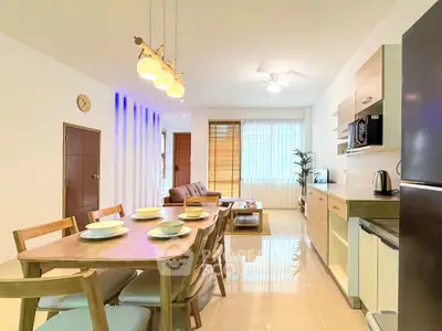 Modern open-plan living and dining area with stylish furniture and natural light.