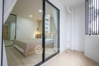 Modern bedroom with glass sliding doors and cozy interior design