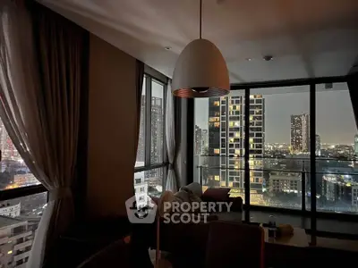 Stunning city view from modern living room with floor-to-ceiling windows and elegant decor.