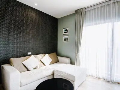 Stylish living room with modern sofa and large window for natural light.