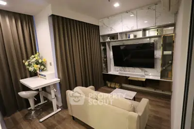 Modern living room with stylish decor and large TV, featuring elegant marble accents and cozy seating area.