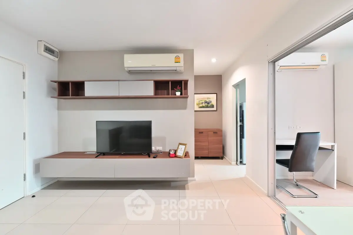 Modern living room with sleek TV unit and air conditioning, perfect for comfortable living.