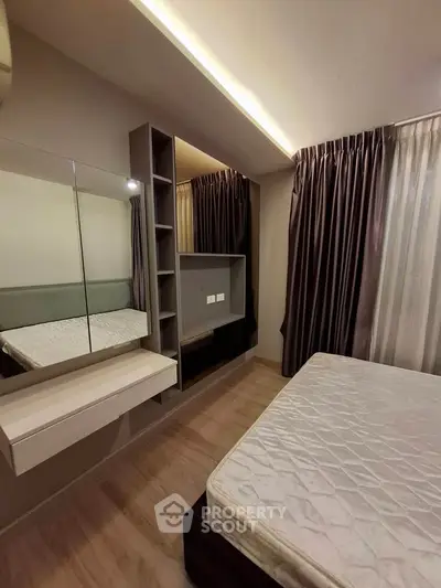 Modern bedroom with sleek design, featuring built-in shelves and elegant curtains.