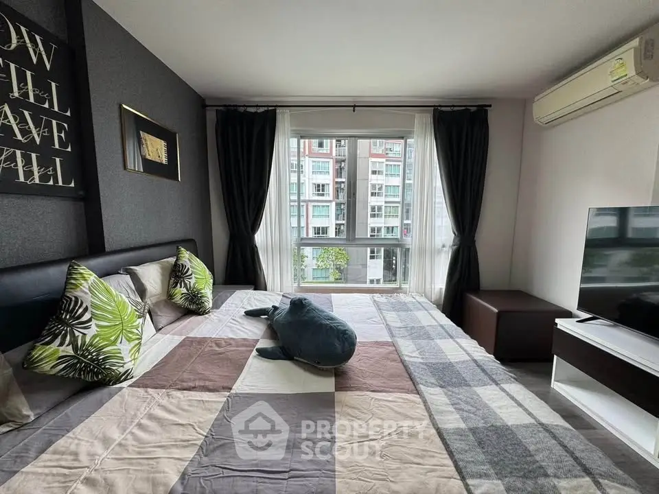 Modern bedroom with large window and stylish decor in urban apartment