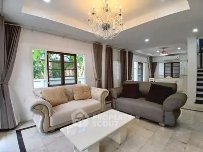 Elegant living room with plush sofas and chandelier in modern home