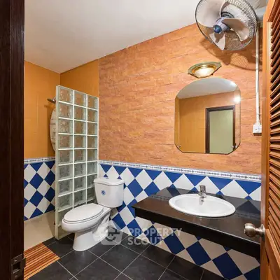 Charming bathroom with unique tile design and modern fixtures in a cozy home.