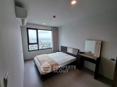 Modern bedroom with city view, featuring a cozy bed and stylish furniture, perfect for urban living.