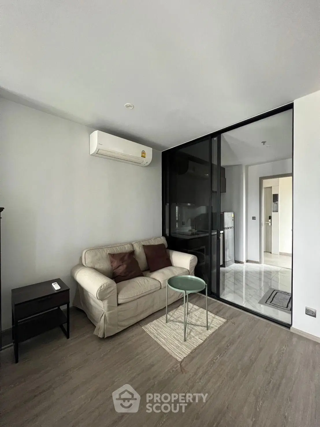 Modern living room with glass partition and air conditioning in stylish apartment
