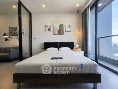 Modern bedroom with large windows and stylish decor in a high-rise apartment.