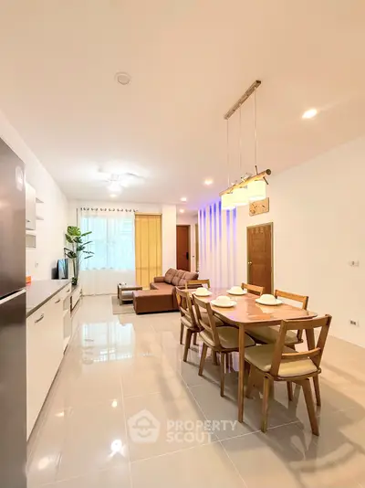 Spacious open-plan living and dining area with modern furnishings and natural light.