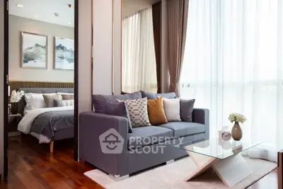 Modern living room with cozy sofa and elegant decor adjacent to stylish bedroom.