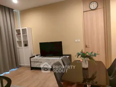 Modern living room with stylish furniture and wall-mounted clock, perfect for cozy gatherings.